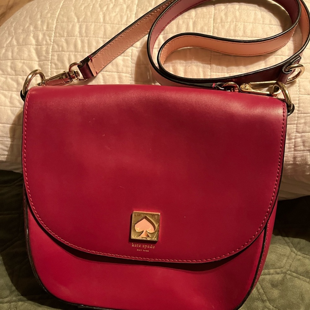 Kate Spade - plum purple crossbody with pink emblem. Like new